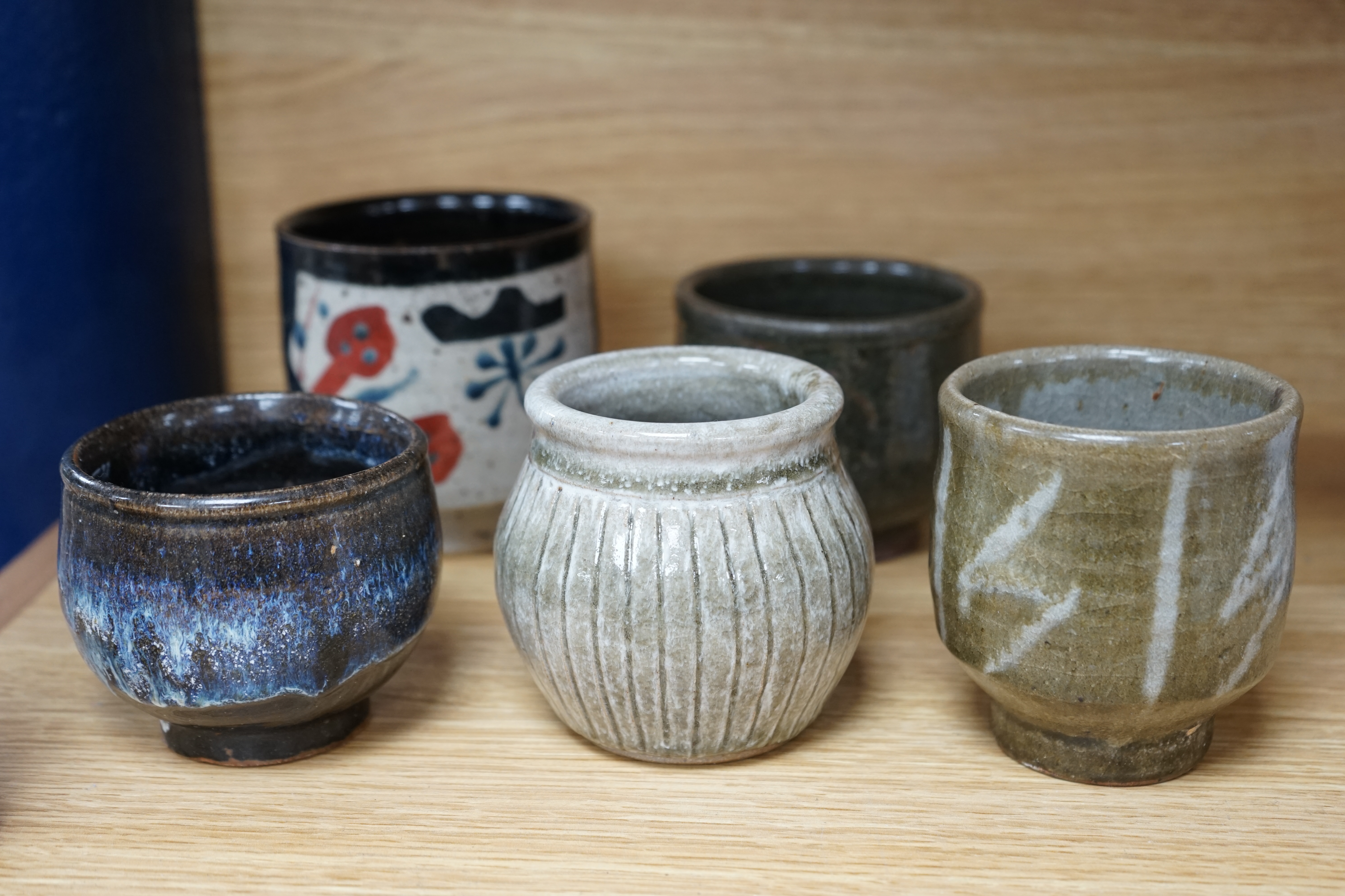 Five Japanese and European studio pottery yunomi, including an example by John Maltby, 10.5cm, together with another signed with a ‘P’ to the base. Condition - good.